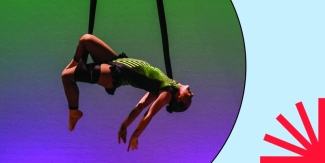 Aerialist dancer performing in green and purple light; photo in circle over blue background with red spark.