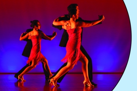 Two couples dancing in red light; picture in circle over light blue background with red spark.